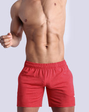 Frontal view of male model wearing the READY RED jogger shorts in a solid red quick-dry by the Bang! brand of men's beachwear from Miami.