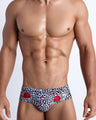 Frontal view of model wearing the SO RED THE ROSE men’s bikini-style bottoms featuring leopard print in white and black tones with red roses by the Bang! menswear brand.