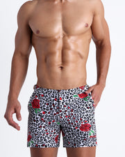 Frontal view of model wearing the SO RED THE ROSE men’s beach tailored shorts featuring leopard print in white and black tones with red roses by the Bang! menswear brand.