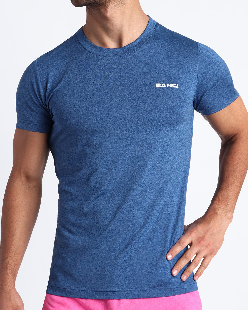 Frontal view of male model wearing the STEEL BLUE in a solid navy quick-dry workout shirt by the Bang! brand of men's beachwear from Miami.