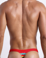 Back side of the Stripe'A'Pose ROUX men’s beach swim bikini in red with colored bands in green, red, yellow and blue by Bang! Miami.