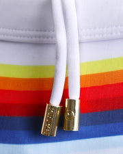 Close-up view of trims of STRIPES ON 45 waistband drawstring, with white cord and custom branded golden cord-ends, and matching custom eyelet trims in gold.