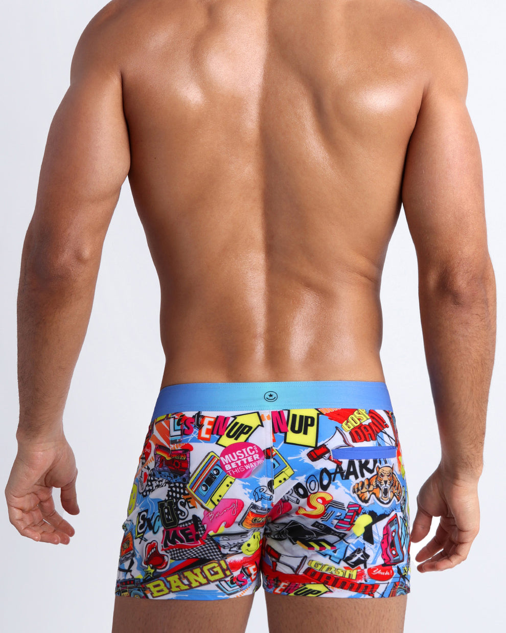Back view of a sexy male model wearing men's swimwear with pop-culture theme made by the Bang! brand of men's beachwear.
