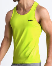 Side view of men’s workout tank top in neon yellow color made by BANG! Clothing the official brand of mens beachwear. 