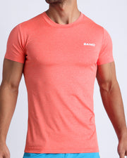 Frontal view of male model wearing the VITAL RED in a solid light red quick-dry workout shirt by the Bang! brand of men's beachwear from Miami.