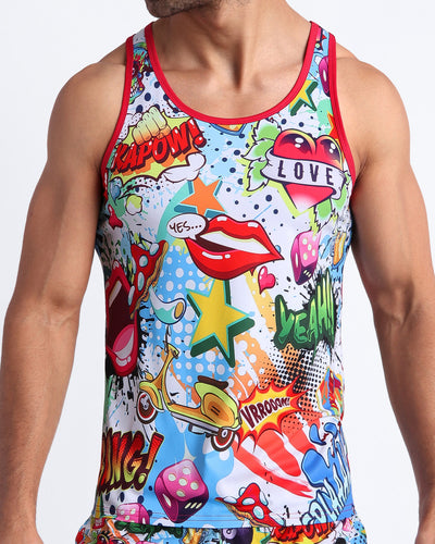 Frontal view of a sexy male model wearing a YEAH-YEAH men's beach tank top feature fun and energetic comics-style graphics in bold colors, with a prominent BANG! illustration.