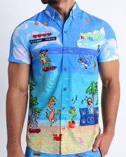 Frontal view of sexy male model wearing the 8-BIT WILD BEACH PARTY men’s short sleeve stretch shirt featuring scenes of retro 80s Nintendo video game, Atari, Sega, Commodore 64.