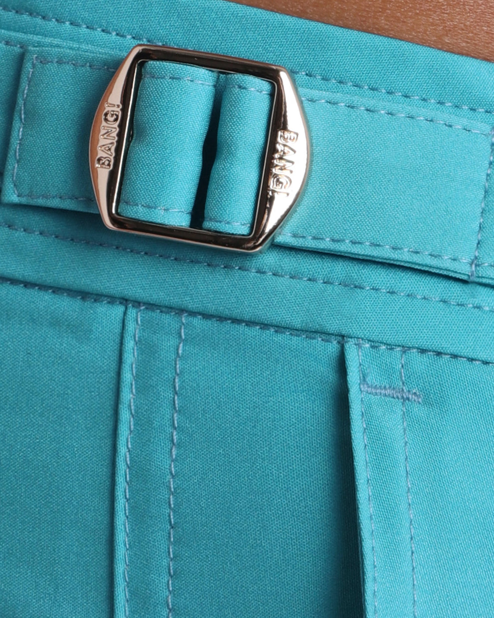 Close-up view of the ATLANTIS men’s swimwear, showing custom branded golden adjustable side buckles.