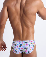 Back view of model wearing the HEY MISTER TJ (POOLSIDE MIX) Men’s beach mini-briefs by BANG! with clubbing and disc-jockey details in dark colors.