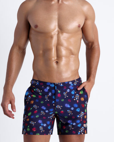 Frontal view of model wearing the HEY MISTER TJ (CLUB MIX) Men’s swim tailored in dark tones with colorful headphones and disc shapes and a dj tiger print by Bang! men's beachwear.