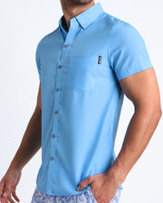 Side view of MAGNET BLUE men’s Summer button down in capri light blue color made by Miami-based Bang Clothing of men's beachwear