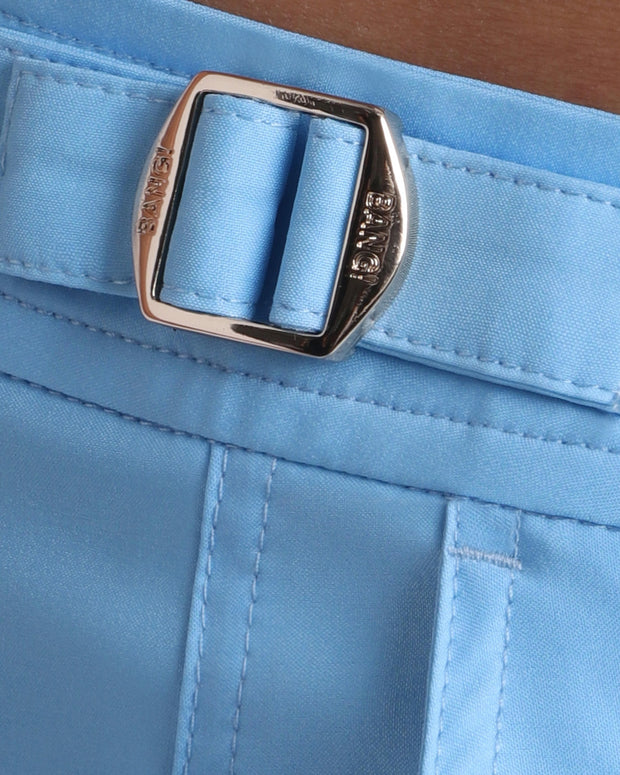 Close-up view of the MAGNET BLUE men’s swimwear, showing custom branded golden adjustable side buckles.