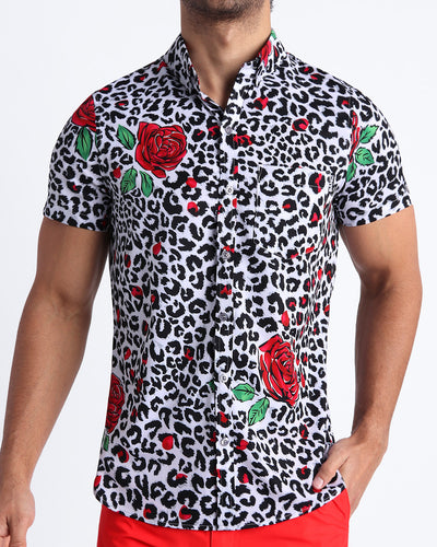Frontal view of model wearing the SO RED THE ROSE men’s short-sleeve stretch shirt featuring leopard print in white and black tones with red roses by the Bang! menswear brand.