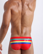 Back side of the Stripe'A'Pose ROUX men’s swim mini-brief in red with colored bands in green, red, yellow and blue by Bang! Miami.