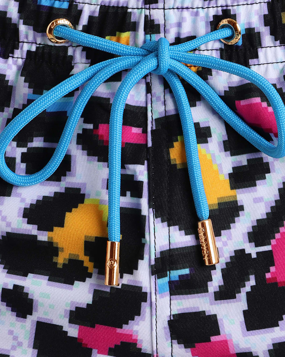 Close-up view of the 8-BIT POP LEOPARD men’s summer shorts, showing black cord with custom branded golden cord ends, and matching custom eyelet trims in gold.