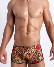 Frontal view of model wearing the CATS N'ROSES men’s swim bottoms featuring leopard print in brown tones with red roses by the Bang! menswear brand.