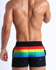 Back side of the FOREVER STRIPES VOL 1 men’s beach trunks in black with colored bands in green, red, yellow and blue by Bang! Miami.