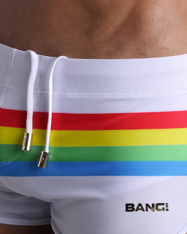 Close-up view of trims of FOREVER STRIPES VOL 2 swimwear for men, with white cord and custom branded golden cord-ends, and matching custom eyelet trims in gold.