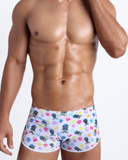 Frontal view of model wearing the HEY MISTER TJ (POOLSIDE MIX) Men’s swim bottoms in white with colorful headphones and disc shapes and a dj tiger print by Bang! men's beachwear.