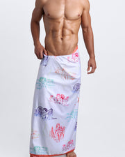 Model showing the OH'LAMOUR quick-dry microfiber towel with matching swim briefs for the beach inspired by 80s techno band erasure and Toile de Jouy scenes.