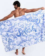 Frontal view of sexy male model showing the SPLASH unisex lightweight towel in white with water strokes in blue and white by Bang! Clothing from Miami.