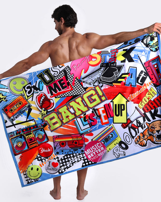 Model showing the STRIPES ON 45 quick-dry microfiber towel with matching swim briefs with pop-culture theme made by the Bang! brand of men&