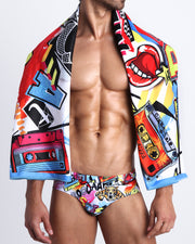 Frontal view of sexy male model showing the SUPER POP unisex lightweight towel  in bold colors, with a prominent BANG! illustration.