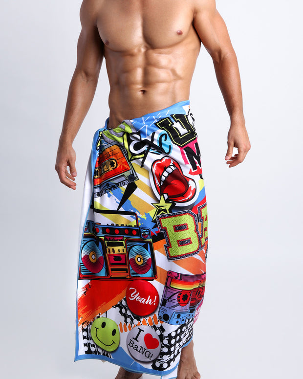Frontal view of sexy male model showing the SUPER POP unisex lightweight towel  in bold colors, with a prominent BANG! illustration.