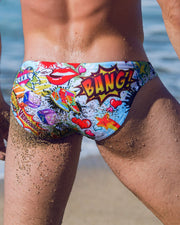 Back view of a sexy male model wearing bang clothes premium swim mini brief yeah yeah print bold colors designer quality fabric