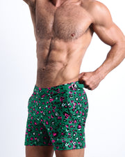 Side view of the men’s CAMO CHAMELEON shorter leg length shorts featuring in teal with pink and black animal print made by Miami based Bang! brand of men's beachwear