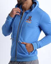 Side view of the CITY BLUE men's full-zip hooded fleece sweatshirt by BANG! Clothes based in Miami. This hoodie is soft and skin-friendly with two pockets to store small things and keep hands warm. 