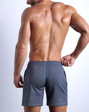 Back view of the COMPOUND BLUE men's fitness sweatshorts in a dark blue color by BANG! menswear Miami.