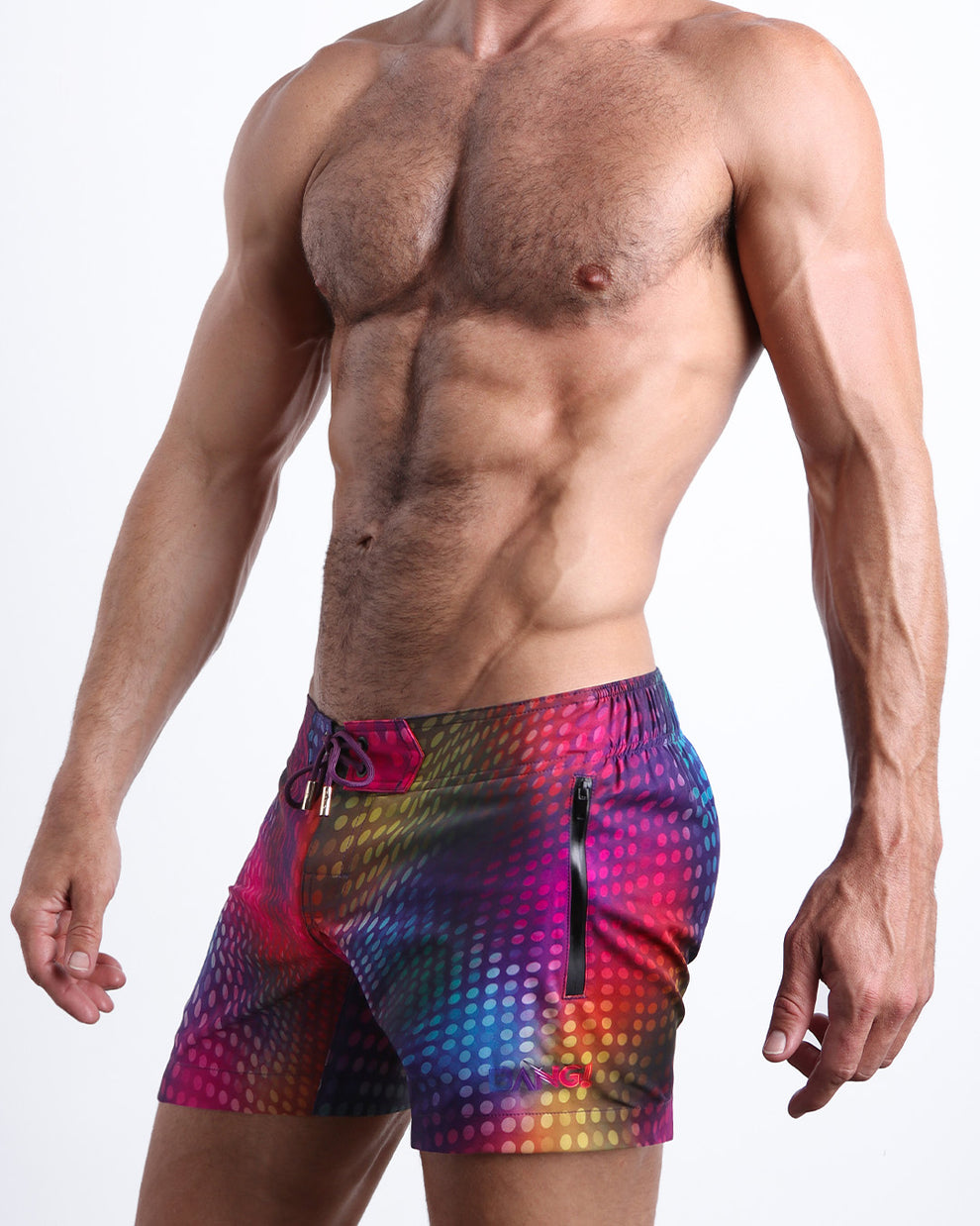 Side view of a man wearing the CONFESSIONS ON A SAND FLOOR shorter leg length swimming shorts with side zipper pocket in a disco ball print by BANG! Clothes.