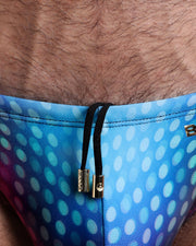 Close-up view of the CONFESSIONS ON A SAND FLOOR men’s summer shorts by BANG! clothing brand, showing black cord with custom branded golden cord ends, and matching custom eyelet trims in gold.