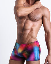 Side view of a masculine model wearing the CONFESSIONS ON A SAND FLOOR compression swimwear shorts in multiple colors Disco Ball design inspired by dance floor and madonna by BANG! Clothes.