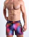 Front view of model wearing the CONFESSIONS ON A SAND FLOOR men’s beach tailored shorts in multiple colors Disco Ball design by the Bang! Clothes brand of men's beachwear from Miami.