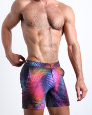 Side view of the men’s CONFESSIONS ON A SAND FLOOR shorter leg length shorts in a pop color disco ball print made by Miami based Bang! brand of men's beachwear