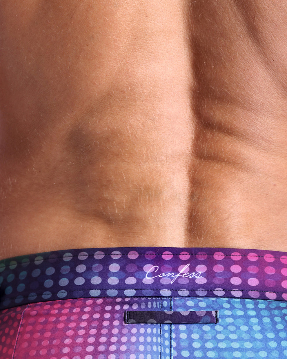 Close-up view of the CONFESSIONS ON A SAND FLOOR men’s swimwear Tailored Shorts with the phrase "Confess" by BANG! Clothes based in Miami