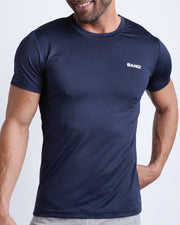 Frontal view of male model wearing the CORE BLUE in a solid dark blue quick-dry workout shirt by the Bang! brand of men's beachwear from Miami.