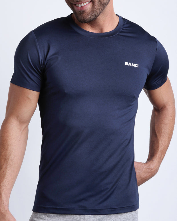Frontal view of male model wearing the CORE BLUE in a solid dark blue quick-dry workout shirt by the Bang! brand of men&
