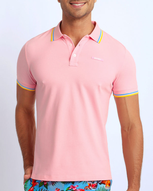 Front view of a sexy male model wearing a premium 100% Cotton Pique Polo Shirt for men from BANG! Brand in a light pink color.