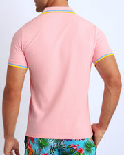 Back view of a sexy model wearing a short-sleeve classic polo shirt for men in a pink color from BANG! Clothing the official brand for menswear.