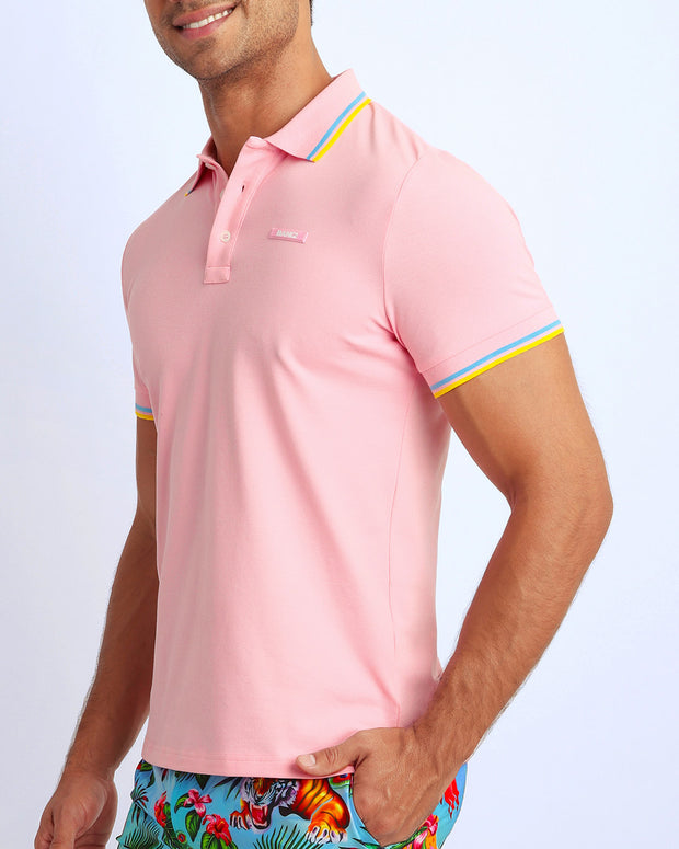 Side view of a male model wearing a slim fit sexy collared shirt for men from BANG! Miami in pink color. 