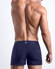Back view of the DAPPER BLUE beach trunks in a dark blue color for men by BANG! menswear Miami.