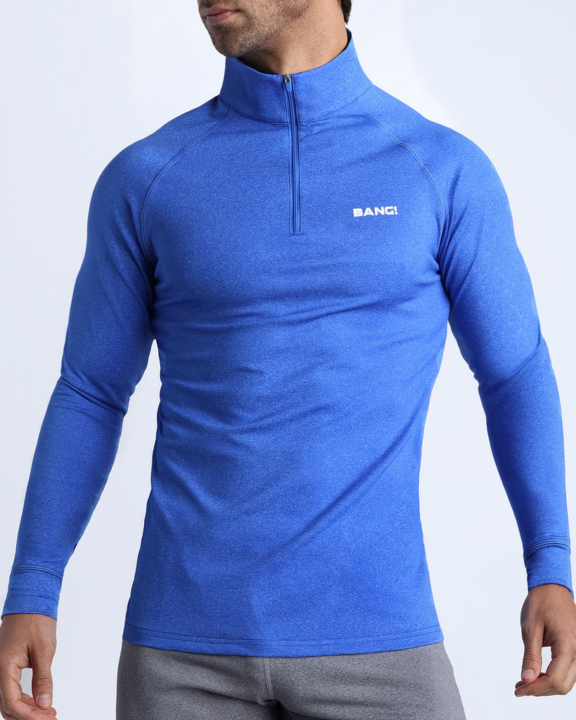 Frontal view of male model wearing the ELECTRIC BLUE in a vibrant blue quick-dry long-sleeve shirt by the Bang! brand of men's beachwear from Miami.