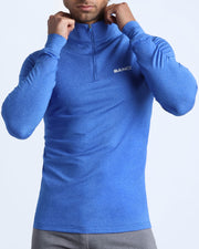 Front view of a sexy male model wearing a workout shirt in a bold blue by bang miami mens brand 2022 gym crossfit yoga fitness