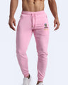 Frontal view of male model wearing the BANG! Clothes EURO PINK Tracksuit Pants with frontal drawstring closure. This athletic jogger has an embroidered Bang! Logo with the signature Mister TJ tiger. 