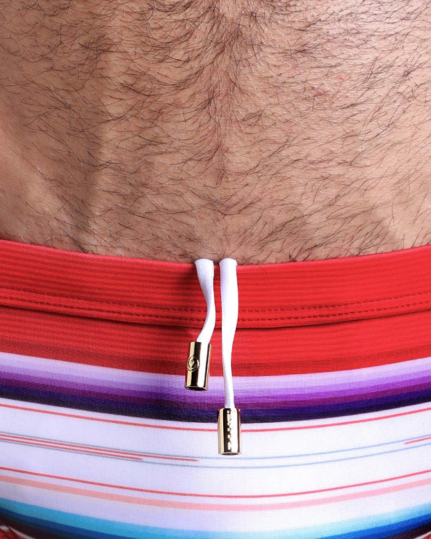 Close-up view of the FAWCETT SARAPE men’s drawstring briefs showing white cord with custom branded golden cord ends, and matching custom eyelet trims in gold.