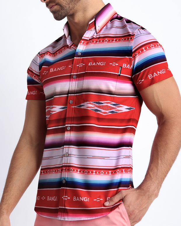 Side view of the FAWCETT SARAPE men’s Summer button down featuring red, blue, purple, white colors inspired by the famous 1976 swimsuit poster of Farrah Fawcett with front pocket by Miami based Bang brand of men&