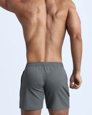 Back view of the FIRM GREY men's fitness sweatshorts in a dark gray color with quick-dry fabric by BANG! menswear Miami.